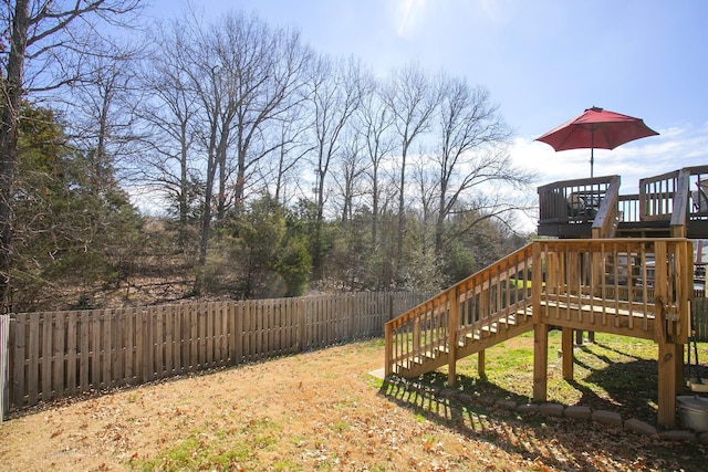 view of yard featuring a fenced backyard, stairway, and a deck