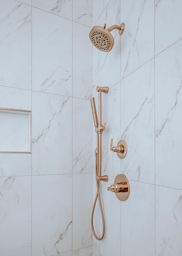 interior details featuring tiled shower