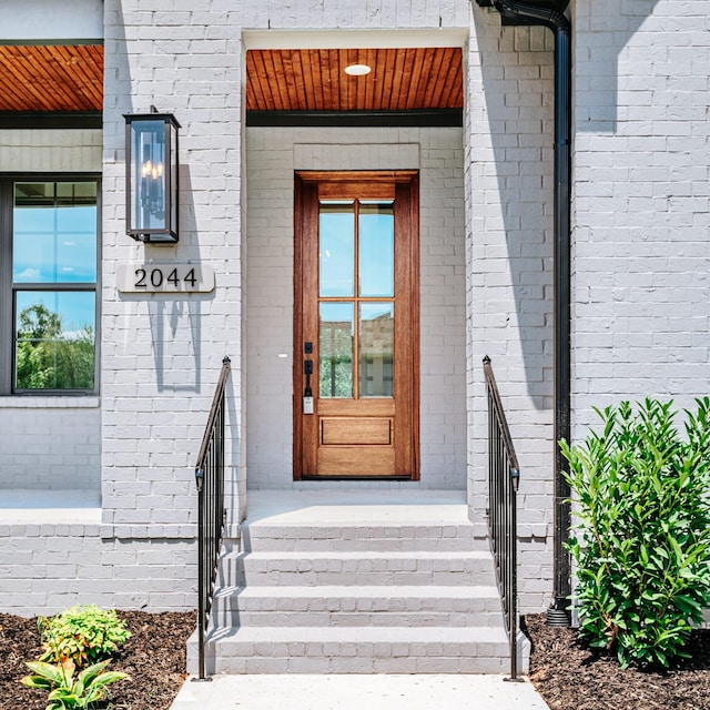 property entrance featuring brick siding