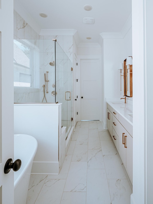 bathroom with vanity, a freestanding bath, marble finish floor, ornamental molding, and a marble finish shower