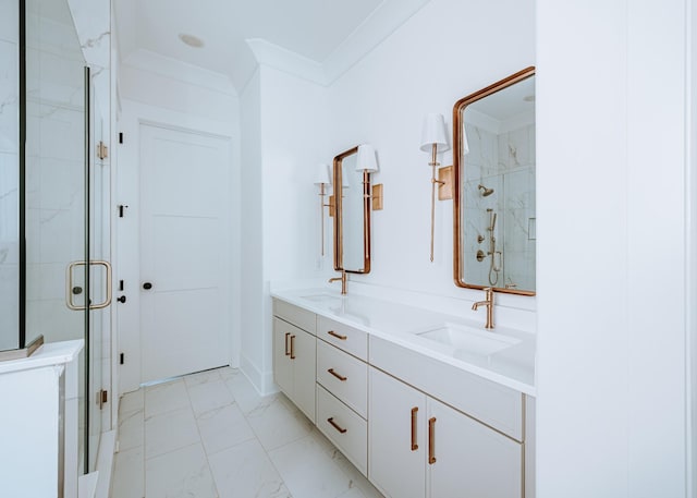 full bathroom with marble finish floor, ornamental molding, a sink, and a shower stall