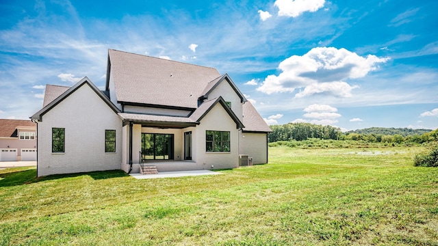 rear view of property with central AC, a lawn, and a patio area