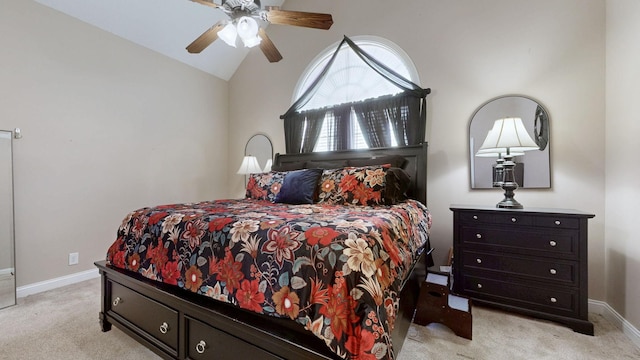 bedroom featuring baseboards, vaulted ceiling, a ceiling fan, and light colored carpet