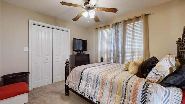 carpeted bedroom featuring ceiling fan and a closet