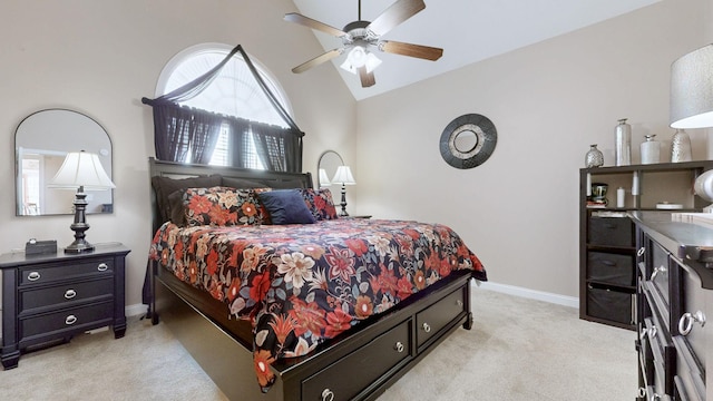 bedroom featuring a ceiling fan, light colored carpet, vaulted ceiling, and baseboards