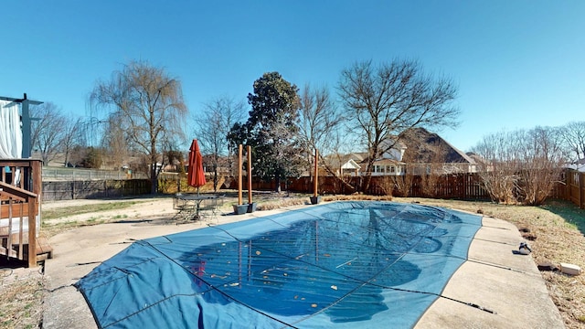 view of pool with a patio area, a fenced backyard, and a fenced in pool