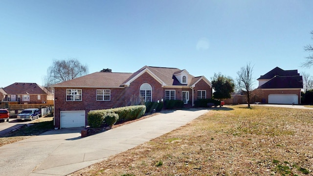 view of front of property featuring a garage, brick siding, fence, concrete driveway, and a front yard