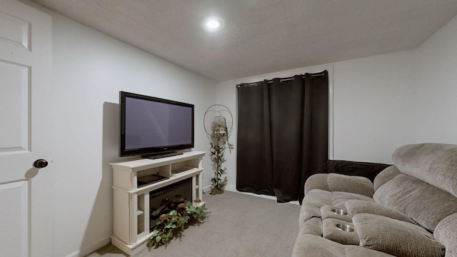 living area featuring light carpet, a textured ceiling, and baseboards