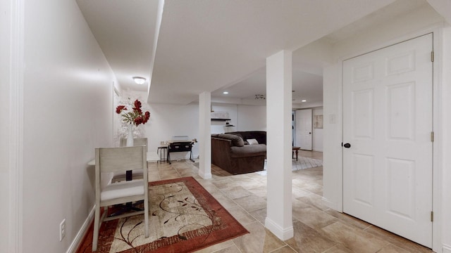 hall with recessed lighting and baseboards