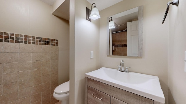 bathroom featuring toilet, walk in shower, and vanity