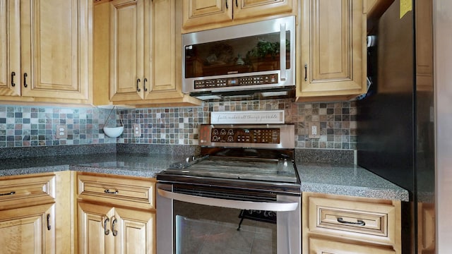 kitchen with light brown cabinets, stainless steel appliances, and decorative backsplash