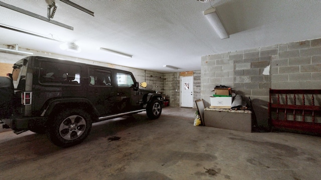 garage with concrete block wall