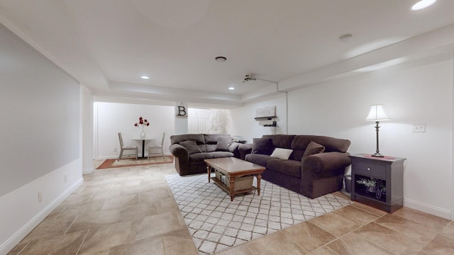 living room featuring baseboards and recessed lighting