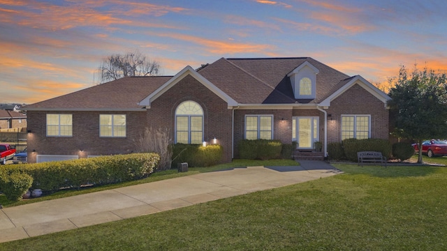 view of front facade featuring a front lawn and brick siding