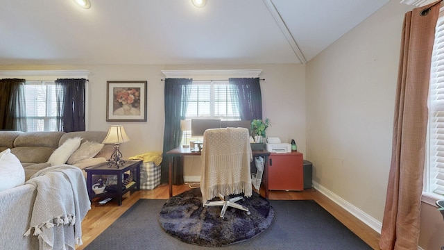 office area with lofted ceiling, a healthy amount of sunlight, baseboards, and wood finished floors