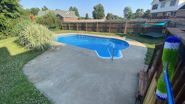 view of pool with a lawn, a patio area, a fenced backyard, and a fenced in pool