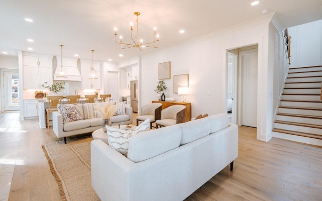 living area with recessed lighting, ornamental molding, light wood-type flooring, baseboards, and stairs