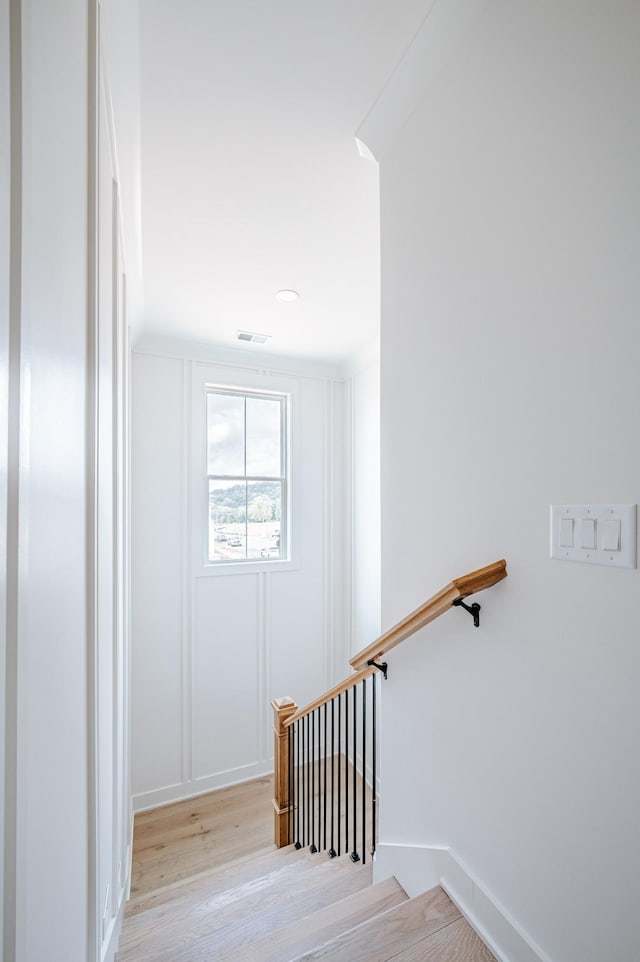 stairs featuring visible vents and wood finished floors