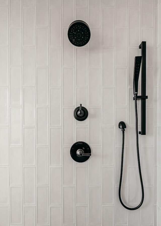 interior details featuring a tile shower