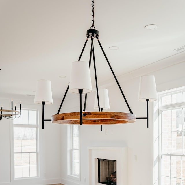 details with recessed lighting, visible vents, and a fireplace