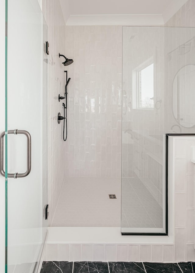 bathroom featuring crown molding and a shower stall