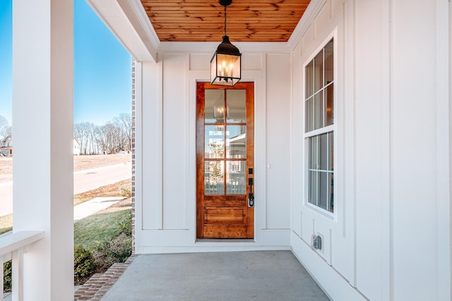 doorway to property featuring board and batten siding and a porch