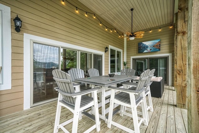 deck featuring ceiling fan and outdoor dining area