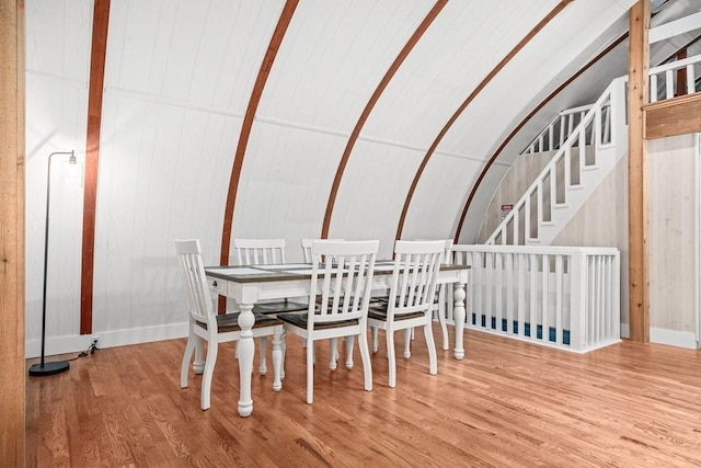 dining area with lofted ceiling and wood finished floors