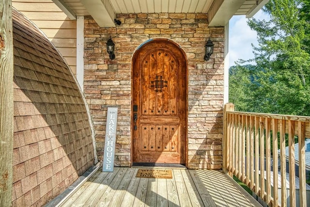 property entrance featuring stone siding and brick siding