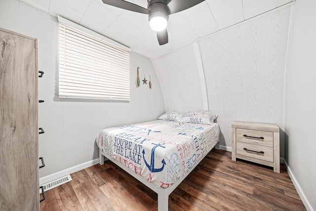 bedroom featuring baseboards, ceiling fan, visible vents, and wood finished floors