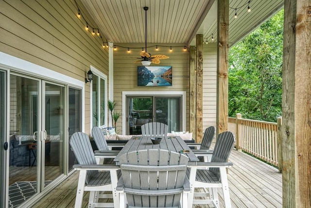 wooden terrace featuring ceiling fan and outdoor dining space