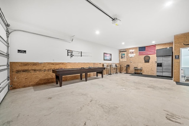 garage featuring built in refrigerator and a garage door opener