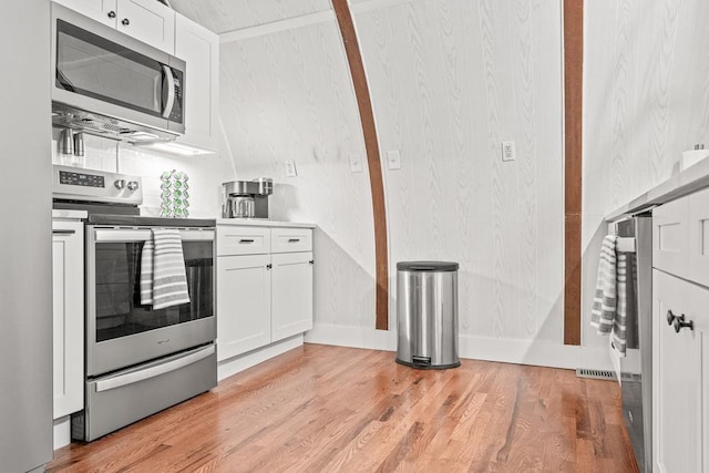 kitchen with light wood-style floors, white cabinetry, appliances with stainless steel finishes, and light countertops