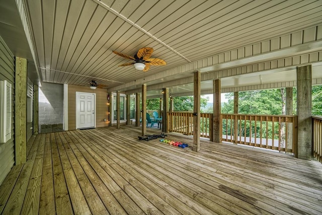 unfurnished sunroom with ceiling fan