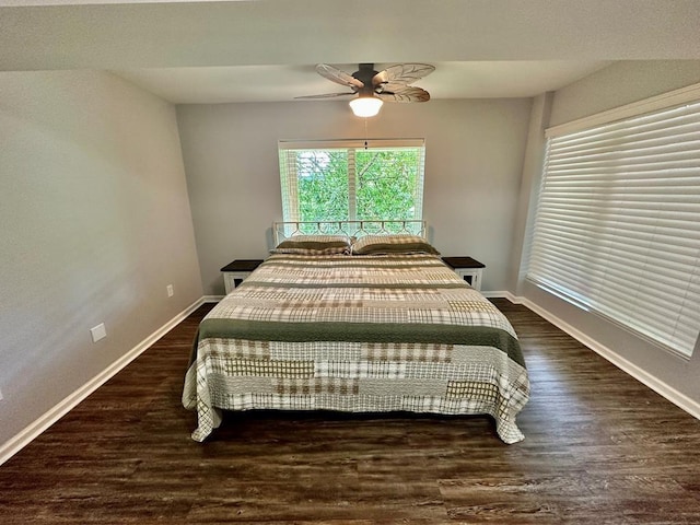 bedroom featuring ceiling fan, baseboards, and wood finished floors