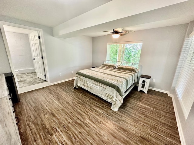 bedroom featuring ensuite bathroom, ceiling fan, baseboards, and wood finished floors