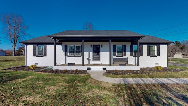 view of front of house with a shingled roof, crawl space, covered porch, a front yard, and brick siding