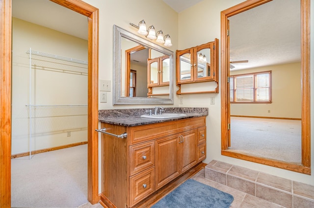 bathroom featuring baseboards and vanity