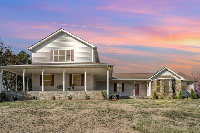 farmhouse-style home featuring a front yard and covered porch