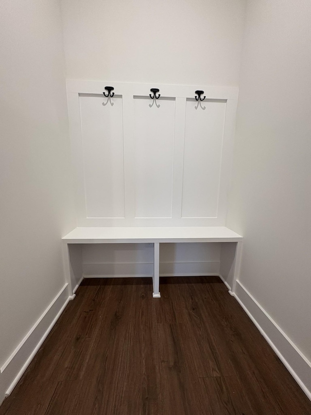 mudroom featuring baseboards and dark wood finished floors