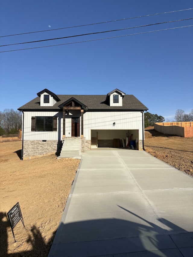 view of front of house with a shingled roof, concrete driveway, crawl space, and a garage