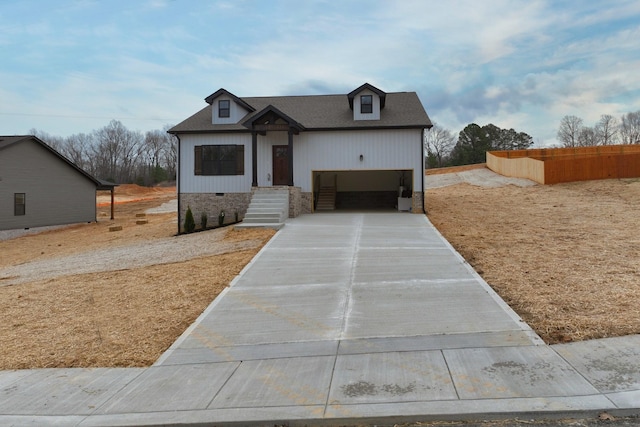 view of front of house with concrete driveway, an attached garage, roof with shingles, and crawl space