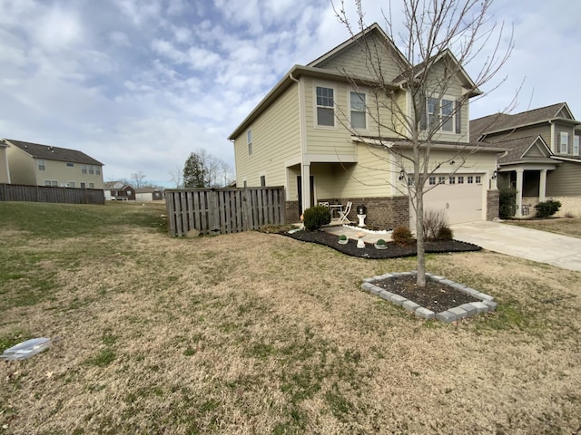 view of front of property featuring brick siding, a front yard, fence, a garage, and driveway