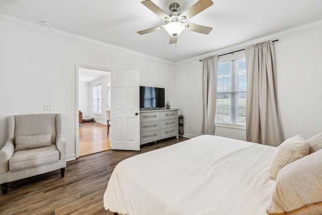 bedroom with ceiling fan, ornamental molding, dark wood-style flooring, and baseboards