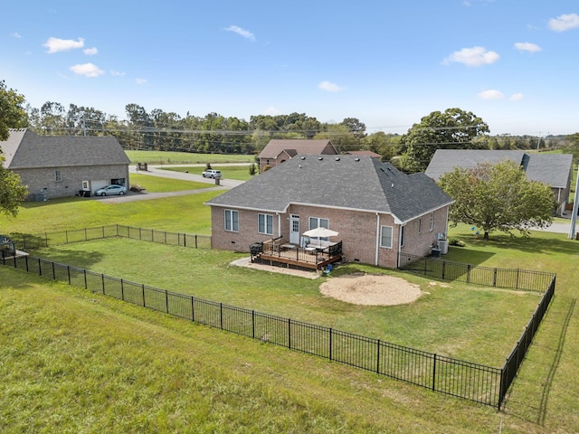 back of house featuring crawl space, brick siding, a yard, and a deck