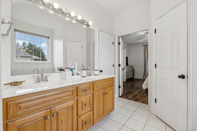 bathroom featuring double vanity, a sink, and tile patterned floors