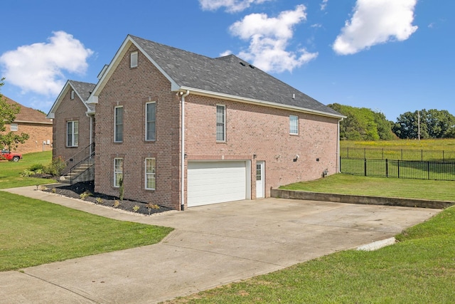 view of home's exterior featuring brick siding, a yard, concrete driveway, an attached garage, and fence