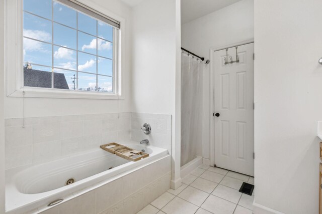 bathroom with a whirlpool tub, a stall shower, and tile patterned floors