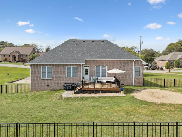 back of house with crawl space, brick siding, a wooden deck, and a yard