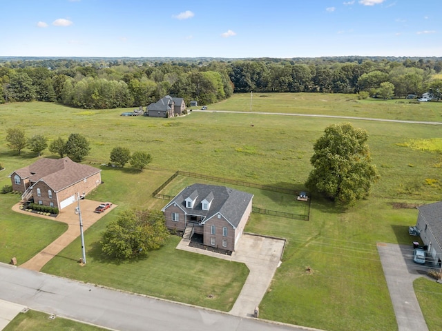 drone / aerial view with a wooded view and a rural view